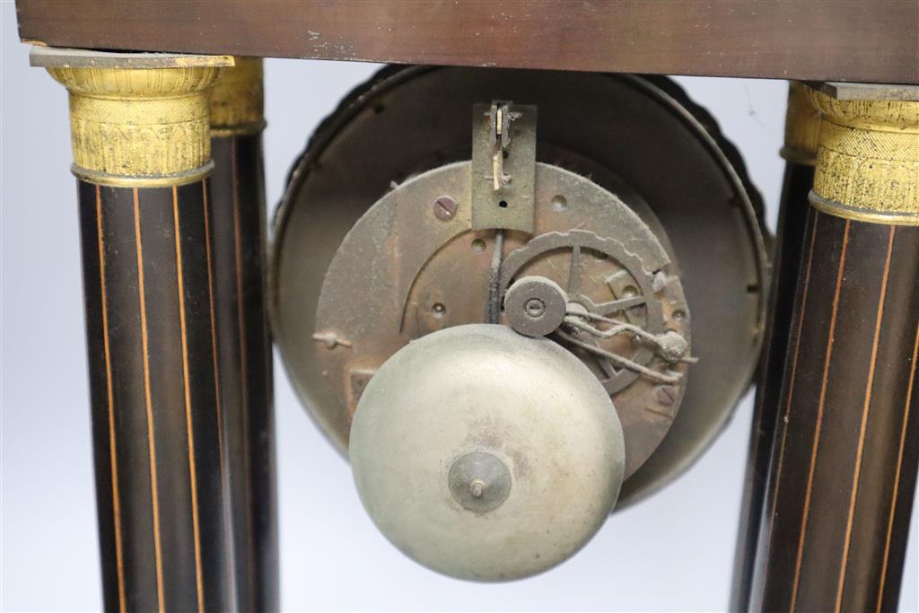 A 19th century inlaid French Portico mantel clock, with cast bacchus pendulum, 49cm